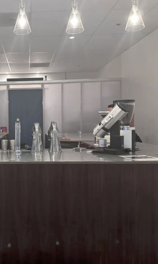 The counter with the espresso grinder and pendant lighting at Endorffeine